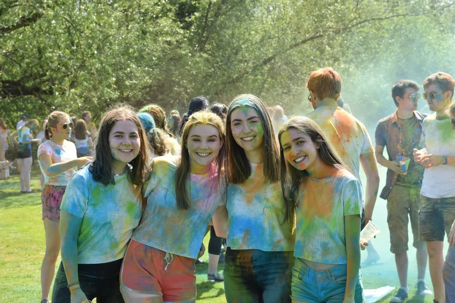 University students celebrating Holi festival with colorful powder